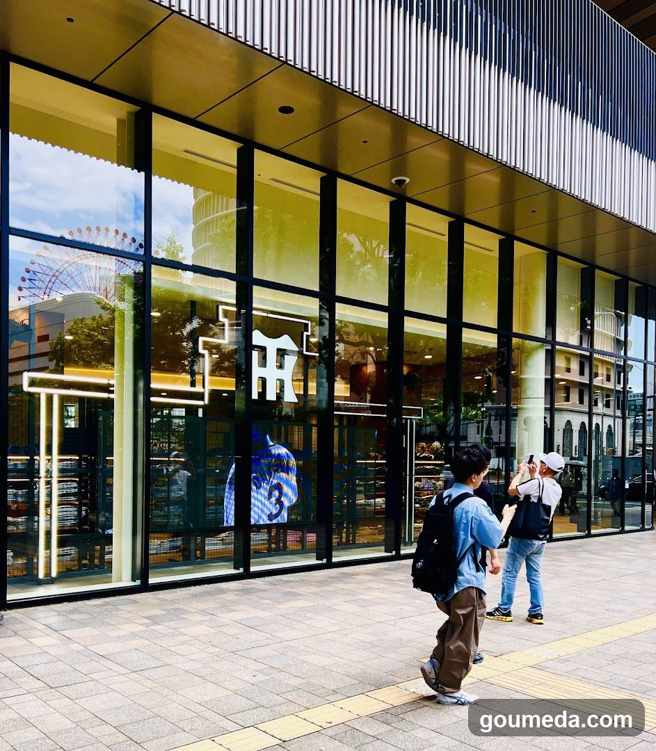 Modern storefront with large glass windows and pedestrians outside