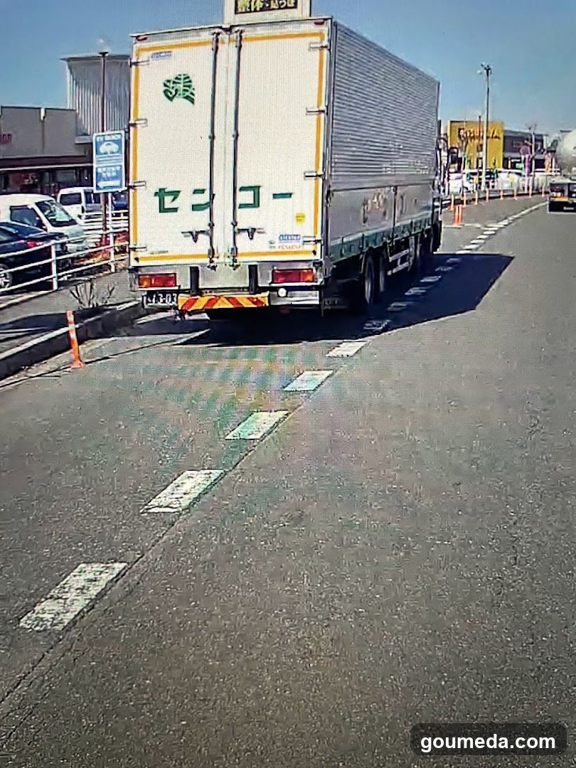 Truck on Road with Storefronts in Background