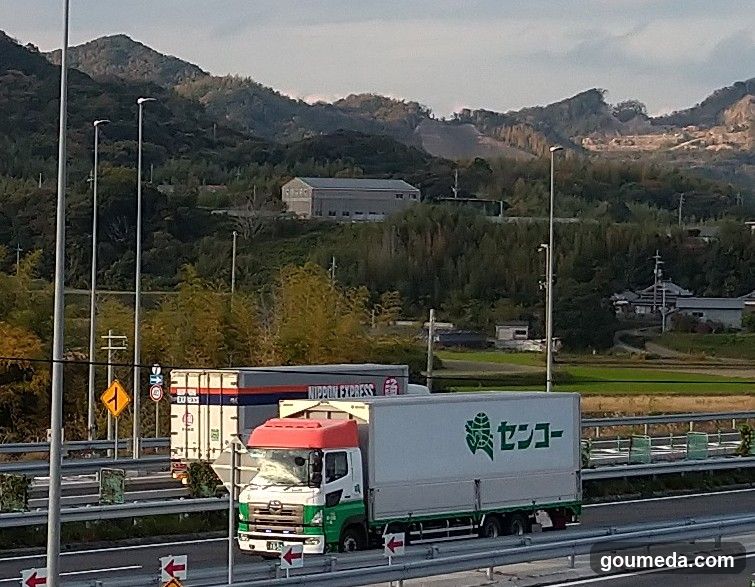 Trucks on Highway with Rural Background