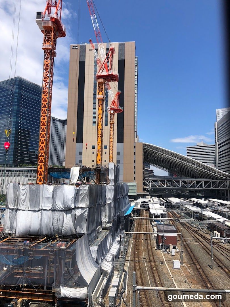 Construction Site with Cranes and Train Tracks