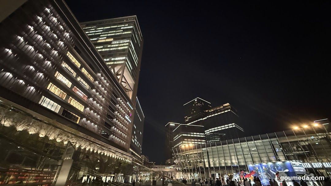 Night Cityscape with Modern Buildings and Crowd