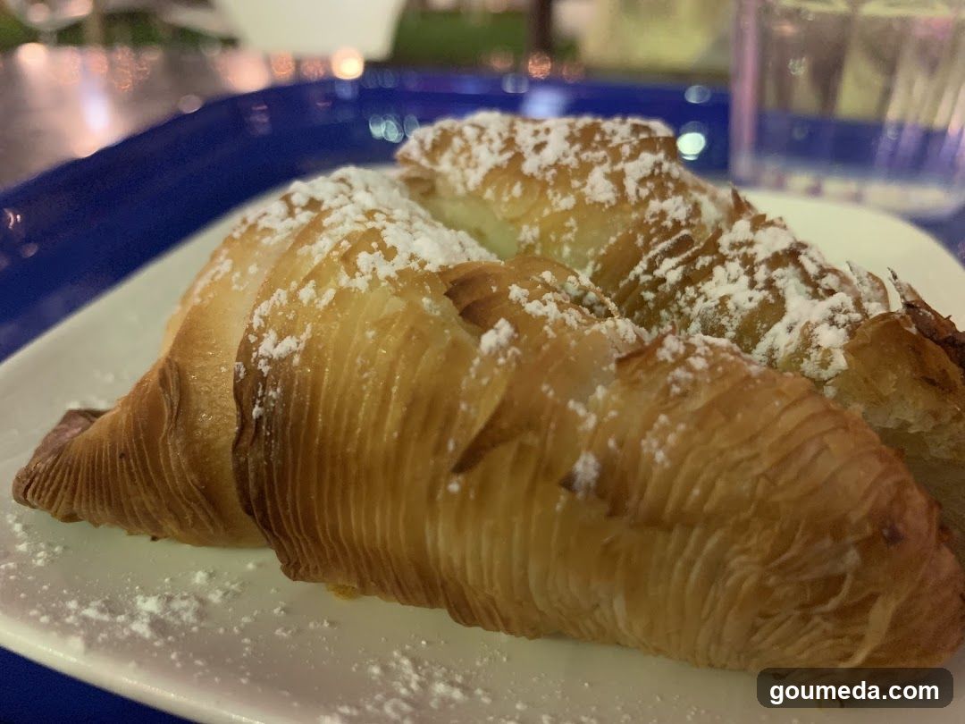 Powdered Croissant on Blue Tray
