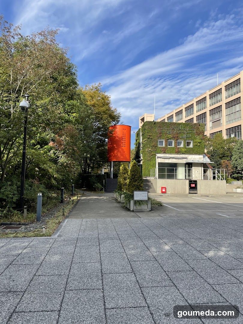 Orange cylindrical structure near building