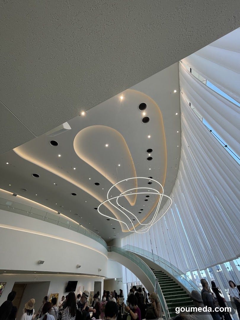 Interior of a modern building with spiral staircase and chandelier