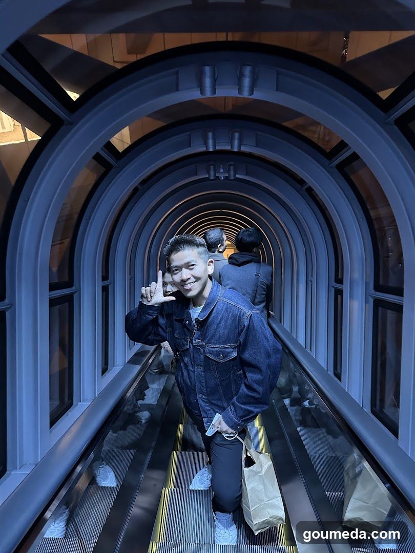 Man on escalator in tunnel