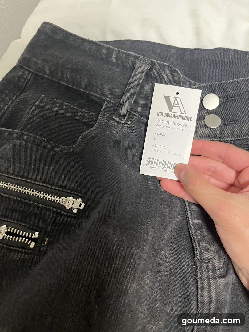 Jeans with tag held by hand