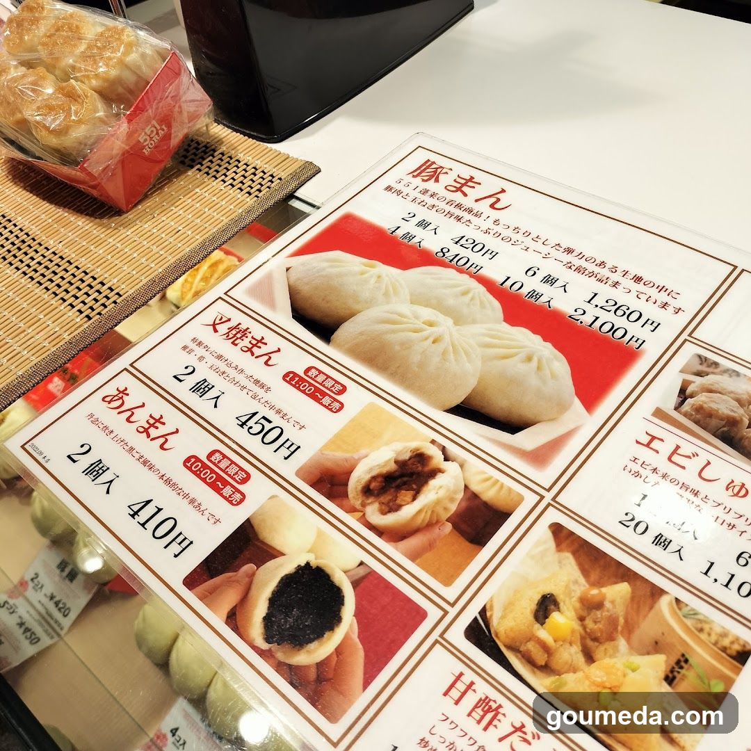A close-up of a Japanese menu board featuring various types of buns, including 'Gyome', 'Yakisoba', and 'Anman'. The menu includes prices in yen and descriptions of the items.
