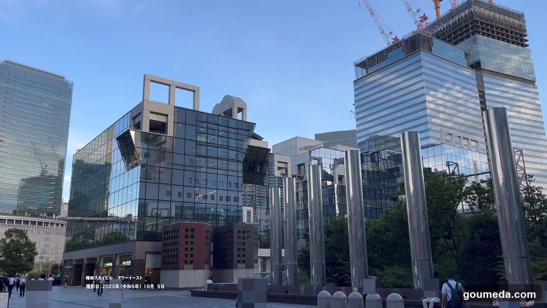 Modern Cityscape with Glass Buildings and Construction Cranes