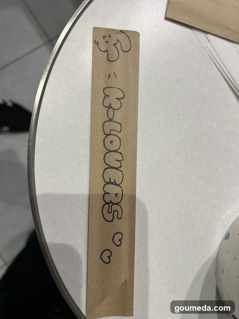 Handwritten note on brown paper strip