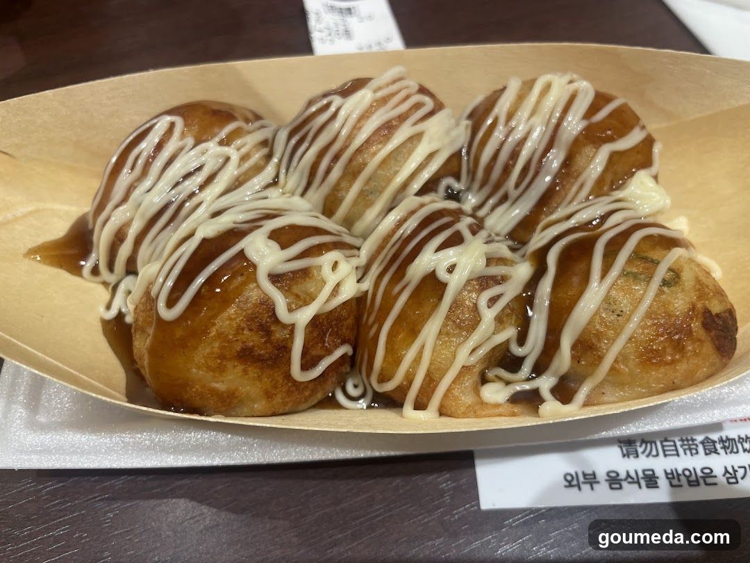 Takoyaki with sauce and mayonnaise drizzle