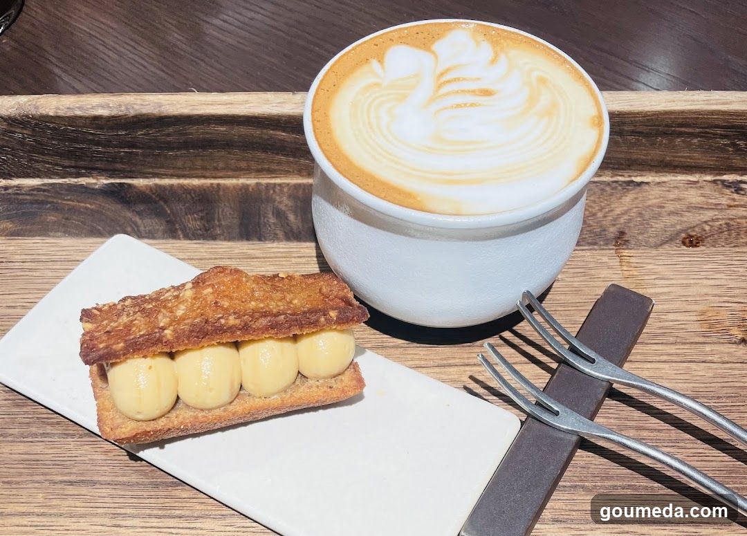 Latte and Pastry on Wooden Tray