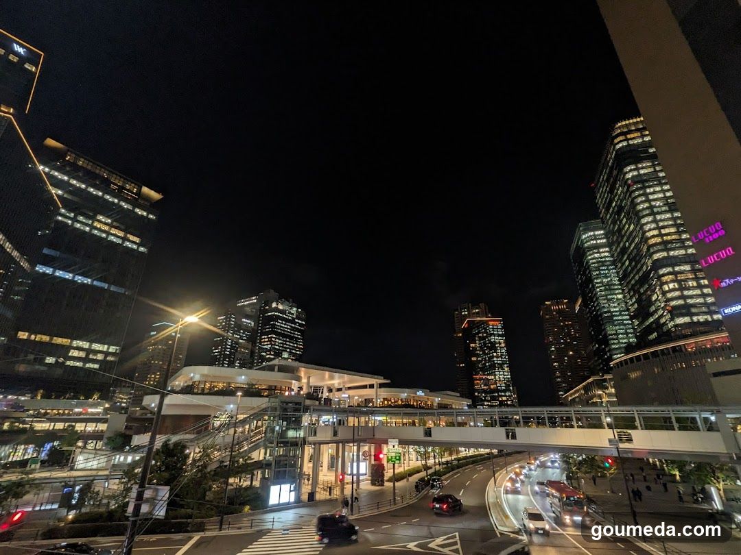 Night Cityscape with Skyscrapers and Pedestrian Bridge