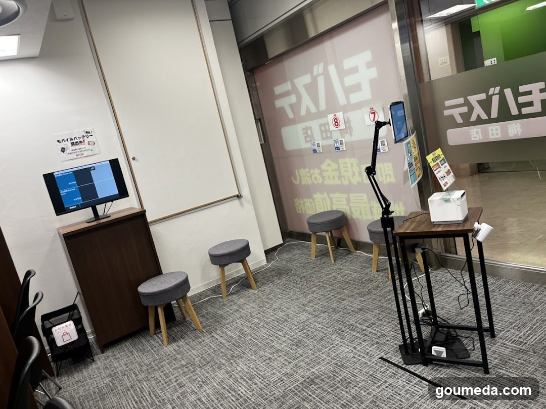Interior waiting area with digital display and stools