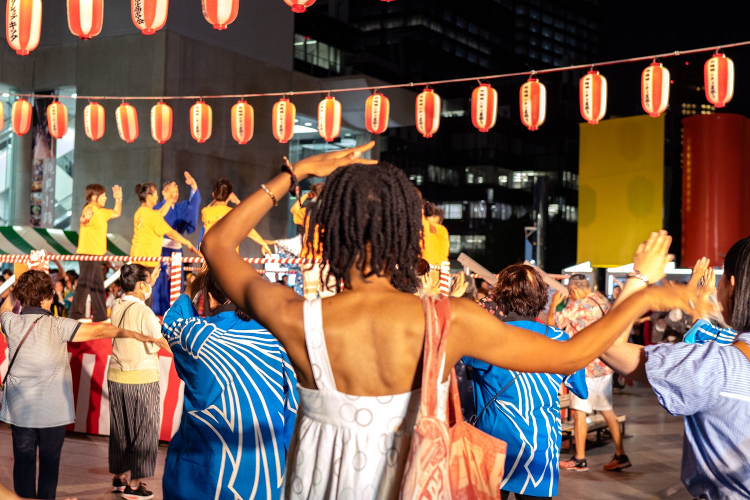 Lanterns illuminated at dusk during the Shin-Umeda City Summer Festival beneath the Umeda Sky Building