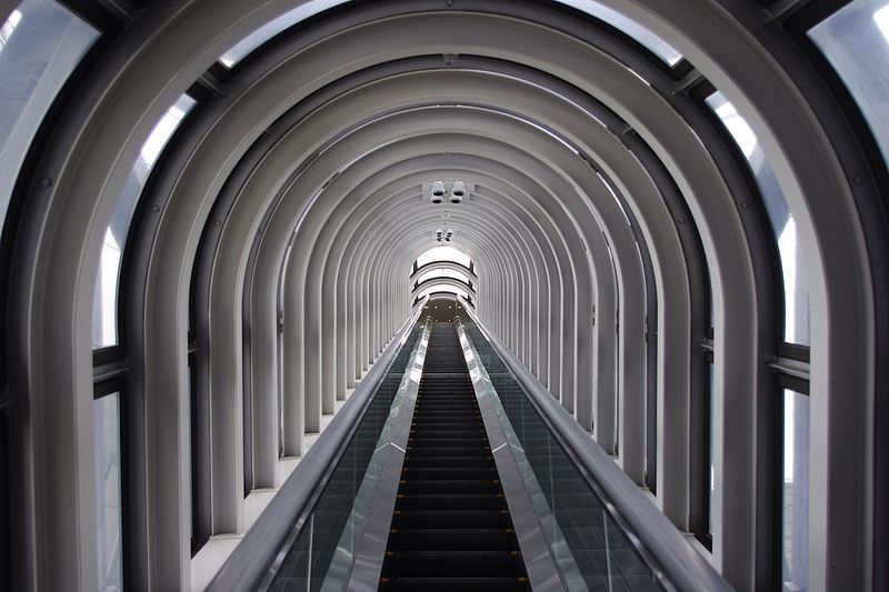Glass-enclosed escalator crossing between the two towers of Umeda Sky Building Osaka