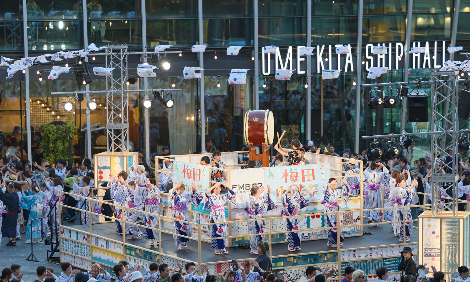 Bon odori dancers circling a yagura tower at Grand Front Osaka Umekita Plaza during the Umeda Yukata Festival